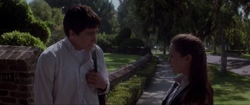 Movie still from “Donnie Darko” (2001), directed by Richard Kelly – A man and a woman talking in a park; Medium shot, Over the shoulder angle