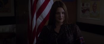 Movie still from “Donnie Darko” (2001), directed by Richard Kelly – A woman standing in front of an american flag; Medium shot, Low angle