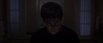 Movie still from “Donnie Darko” (2001), directed by Richard Kelly – A young man is looking down at his face; Close Up shot, High angle