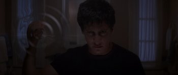 Movie still from “Donnie Darko” (2001), directed by Richard Kelly – A young man stares into the camera in a dark room; Close Up shot, Low angle