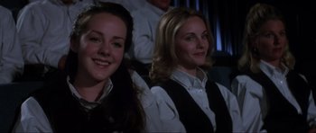 Movie still from “Donnie Darko” (2001), directed by Richard Kelly – Two women are sitting in a movie theater smiling; Close Up shot, Low angle