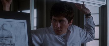Movie still from “Donnie Darko” (2001), directed by Richard Kelly – A man in a white shirt looking at a mirror; Close Up shot, Over the shoulder angle