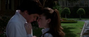 Movie still from “Donnie Darko” (2001), directed by Richard Kelly – A man and a woman standing next to each other in the grass; Medium shot, Low angle