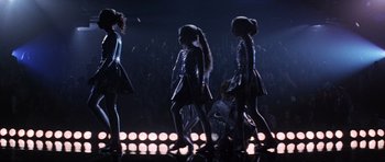 Movie still from “Donnie Darko” (2001), directed by Richard Kelly – A group of young girls walking across a stage; Wide shot, Low angle