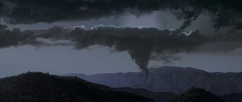 Movie still from “Donnie Darko” (2001), directed by Richard Kelly – A dark cloud is coming out of the sky; Extreme Wide shot, High angle