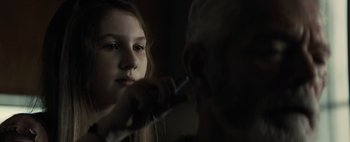 Movie still from “Don't Breathe 2” (2021), directed by Rodo Sayagues – A young girl brushes her teeth with an older man; Close Up shot, Over the shoulder angle