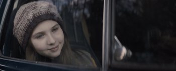 Movie still from “Don't Breathe 2” (2021), directed by Rodo Sayagues – A woman sitting in the driver's seat of a car; Close Up shot, Over the shoulder angle
