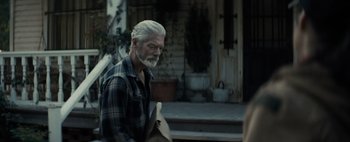 Movie still from “Don't Breathe 2” (2021), directed by Rodo Sayagues – An older man with white hair and a gray beard; Medium shot, Over the shoulder angle