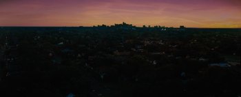 Movie still from “Don't Breathe 2” (2021), directed by Rodo Sayagues – A view of a city at night from a hill; Extreme Wide shot, Low angle