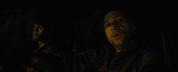 Movie still from “Don't Breathe 2” (2021), directed by Rodo Sayagues – A man in a hooded jacket looking into the camera; Close Up shot, Over the shoulder angle