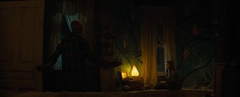 Movie still from “Don't Breathe 2” (2021), directed by Rodo Sayagues – A man standing in front of a fire in a living room; Wide shot, Low angle