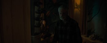 Movie still from “Don't Breathe 2” (2021), directed by Rodo Sayagues – An older man and a younger woman in a dark room; Medium shot, Over the shoulder angle