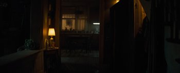 Movie still from “Don't Breathe 2” (2021), directed by Rodo Sayagues – A dark room with a table and chairs in it; Wide shot, High angle
