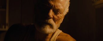 Movie still from “Don't Breathe 2” (2021), directed by Rodo Sayagues – An old man with white hair and a white beard; Extreme Close Up shot, Low angle