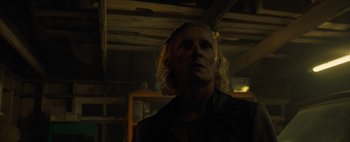 Movie still from “Don't Breathe 2” (2021), directed by Rodo Sayagues – A man with blonde hair is standing in the dark; Close Up shot, Low angle