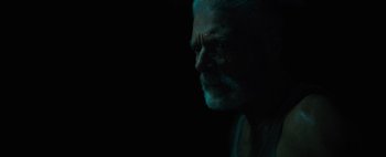 Movie still from “Don't Breathe 2” (2021), directed by Rodo Sayagues – An old man with a beard is looking into the distance; Close Up shot, Over the shoulder angle