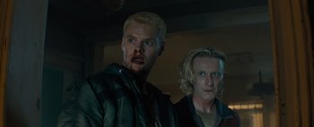 Movie still from “Don't Breathe 2” (2021), directed by Rodo Sayagues – Two men are standing next to each other in a room; Close Up shot, Low angle
