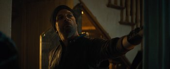 Movie still from “Don't Breathe 2” (2021), directed by Rodo Sayagues – A man standing in a room with a hat on his head; Close Up shot, Over the shoulder angle