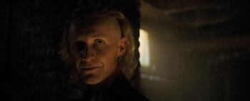 Movie still from “Don't Breathe 2” (2021), directed by Rodo Sayagues – A man with blonde hair is looking at the camera; Close Up shot, Low angle