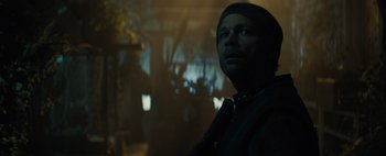 Movie still from “Don't Breathe 2” (2021), directed by Rodo Sayagues – A man wearing a black tie and a black shirt; Close Up shot, Over the shoulder angle