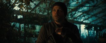 Movie still from “Don't Breathe 2” (2021), directed by Rodo Sayagues – A man in a black jacket and a black hat; Close Up shot, Low angle