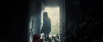 Movie still from “Don't Breathe 2” (2021), directed by Rodo Sayagues – A woman standing in front of an open door; Wide shot, Over the shoulder angle