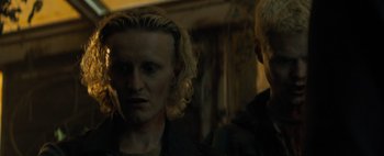 Movie still from “Don't Breathe 2” (2021), directed by Rodo Sayagues – A man with blonde curly hair and a man with blond hair; Close Up shot, Low angle