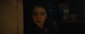 Movie still from “Don't Breathe 2” (2021), directed by Rodo Sayagues – A young girl with long dark hair is looking at the camera; Close Up shot, Low angle