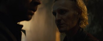 Movie still from “Don't Breathe 2” (2021), directed by Rodo Sayagues – A person's face in a dark room; Close Up shot, Over the shoulder angle