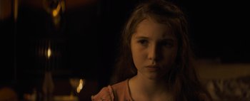 Movie still from “Don't Breathe 2” (2021), directed by Rodo Sayagues – A young girl is looking into the camera; Close Up shot, Over the shoulder angle