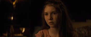 Movie still from “Don't Breathe 2” (2021), directed by Rodo Sayagues – A young girl with long red hair stares into the camera; Close Up shot, Over the shoulder angle