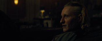 Movie still from “Don't Breathe 2” (2021), directed by Rodo Sayagues – A person sitting on a couch; Close Up shot, Over the shoulder angle