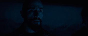 Movie still from “Don't Breathe 2” (2021), directed by Rodo Sayagues – A man with a goatee stares into the camera; Close Up shot, Low angle