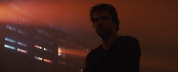 Movie still from “Don't Breathe 2” (2021), directed by Rodo Sayagues – A man standing in front of a red light; Close Up shot, Low angle