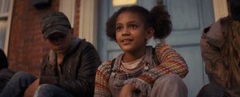 Movie still from “Don't Breathe 2” (2021), directed by Rodo Sayagues – A young girl sitting on a chair looking at the camera; Close Up shot, Low angle