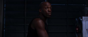 Movie still from “Doom” (2005), directed by Andrzej Bartkowiak – A man in a black tank top is looking at the camera; Close Up shot, Low angle