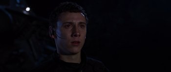 Movie still from “Doom” (2005), directed by Andrzej Bartkowiak – A man with a headset in a dark room; Close Up shot, Low angle