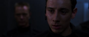 Movie still from “Doom” (2005), directed by Andrzej Bartkowiak – A person wearing a black shirt; Close Up shot, Over the shoulder angle