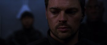 Movie still from “Doom” (2005), directed by Andrzej Bartkowiak – A man's face in the dark; Close Up shot, Over the shoulder angle