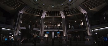 Movie still from “Doom” (2005), directed by Andrzej Bartkowiak – People are standing in front of a building with lights on; Extreme Wide shot, High angle