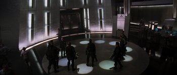 Movie still from “Doom” (2005), directed by Andrzej Bartkowiak – A group of people standing in a room with lights on the floor; Extreme Wide shot, High angle