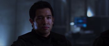 Movie still from “Doom” (2005), directed by Andrzej Bartkowiak – A person wearing a black shirt; Close Up shot, Over the shoulder angle