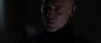 Movie still from “Doom” (2005), directed by Andrzej Bartkowiak – A man's face in the dark; Close Up shot, Over the shoulder angle