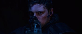 Movie still from “Doom” (2005), directed by Andrzej Bartkowiak – A person holding a gun in the dark; Close Up shot, Low angle
