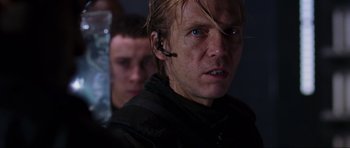 Movie still from “Doom” (2005), directed by Andrzej Bartkowiak – A person with a headset on; Close Up shot, Over the shoulder angle