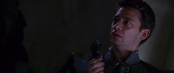 Movie still from “Doom” (2005), directed by Andrzej Bartkowiak – A man holding a gun up to his face; Close Up shot, Low angle