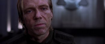 Movie still from “Doom” (2005), directed by Andrzej Bartkowiak – A man's face in a dark room; Close Up shot, Over the shoulder angle