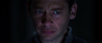 Movie still from “Doom” (2005), directed by Andrzej Bartkowiak – A man's face in the dark; Close Up shot, Low angle