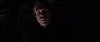 Movie still from “Doom” (2005), directed by Andrzej Bartkowiak – A person in a dark room; Close Up shot, Low angle