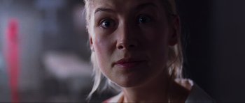 Movie still from “Doom” (2005), directed by Andrzej Bartkowiak – A woman's face in a dimly - lit room; Close Up shot, Low angle